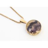 A Blue John and 9ct gold pendant, comprising a double sided round form set either side with Blue