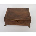 Early 19th century mahogany trinket box with veneered borders, lions' feet and two brass carry