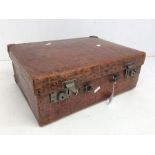 A vintage crocodile suit case, the locks stamped: DREW & SONS, Picadilly Circus London W1., handle