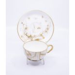 An Aesthetic Movement tea cup and saucer, probably Minton, circa 1875,  the cup with a hand