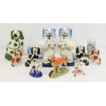 A collection of 19th & early 20th Century Staffordshire model of various dogs to include: a pair