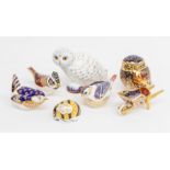 A collection of Royal Crown Derby paperweights and a model of a Wheelbarrow, date code MMI, boxed;