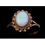 An opal and 9ct gold ring, comprising an oval opal approx 6 x 9mm, within a rope twist border, split