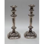 A pair of 19th Century style silver plated candlesticks, detachable drip pans above knopped stems,
