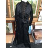A black early 1900's dress in sateen (a mix of satin and silk) the bodice of the dress is