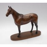 A connoisseur model by Beswick of Arkle Champion Steeplechaser on wooden stand.