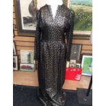 A gold lami dress, size 12, Thea Porter; gold lami leaf design on black background, v neckline, long