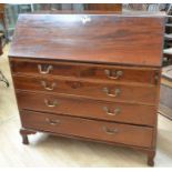 A large mahogany George III bureau on bracket feet with a drop-down writing top above two small