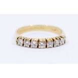 A diamond and 14ct gold half eternity ring, set to the front with seven round brilliant cut