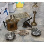 A collection of metal wares including a trivet, oil lamp, desk press and others