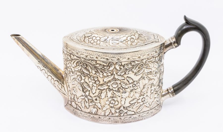 A George III silver shaped oval teapot, later embossed with scrolling foliage and flowers, ebony C- - Image 2 of 3