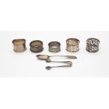 Five various early 20th Century silver napkin rings with a Scottish fiddle pattern teaspoon and