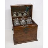 Early 20th century oak three decanter Tantalus box with internal mirror, drop-down mixing shelf with