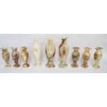 A collection of onyx vases: three large and six small