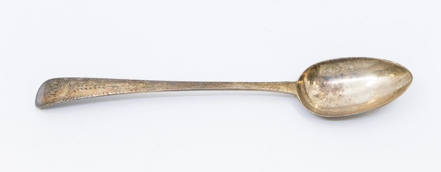 A George III bright-cut engraved serving spoon, hallmarked by Hester Bateman, London, 1785, approx