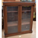 Late 19th century glazed mahogany bookcase with four shelves behind two doors