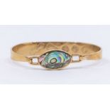 A 9ct gold and abalone set bangle, hinged top set with an oval abalone, width approx 15mm,