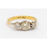 A three stone diamond and 18ct gold ring, comprising graduated old cut diamonds claw set, total