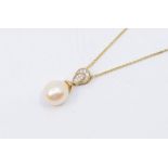 A cultured pearl and diamond set  9ct gold pendant, comprising a white pear shaped cultured pearl