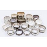 A collection of mainly late 19th/early 20th Century silver napkin rings, various designs, dates