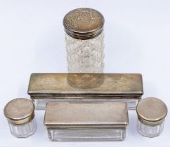 A set of four Victorian silver mounted cut glass travelling / dressing table bottles, the cover