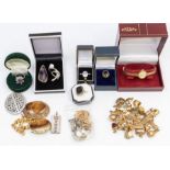 A collection of 9ct gold charms, to include £10 note, coffee bean, elephant, spinning wheel,