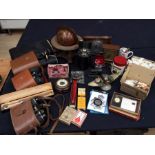 Mixed lot containing binoculars, police badge, travel clocks, globe, figures etc