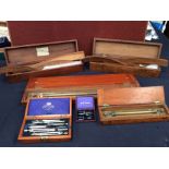 A collection of early to mid 20th century wooden cased draughtsman's instruments and items