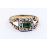 A Georgian emerald and diamond ring, comprising  a central rectangular cut emerald, within a