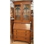 1930s light oak bureau Bookcase with stained glass cupboard doors to reveal three bookshelves, and a