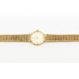 Omega: A Ladies 9ct gold wristwatch, round champagne dial with baton markers, case approx. 17mm,