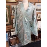 A 1920's pale blue satin kimono, used as a dressy robe, embroidered with the cherry blossom