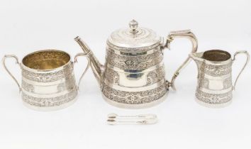 A Victoria Anglo-Indian style three piece silver tea service comprising teapot, sugar bowl, milk