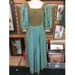 A maxi dress, size 12, Thea Porter; in turquoise with gold flower design, square neck and yoke,