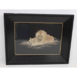 An early 20th Century embroidery in ebonised frame of a lion and lioness