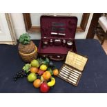 1970s pineapple ice bucket, 1970s fake fruit, and vanity case with butter knives.