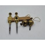 A pair of Preston steel tipped brass trammels, together with two brass plumb bombs. (2)