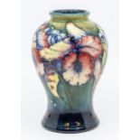 A Moorcroft Iris pattern baluster vase, signed, approx. 15cm high. Condition: good. Impressed '