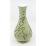 A large Moorcroft green-glazed, tubelined decoration, signed vase. Approximately 19cm high.