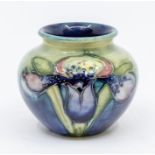 A small Moorcroft Iris patterned green and blue glazed small pot, marked on the base, approx. 6.