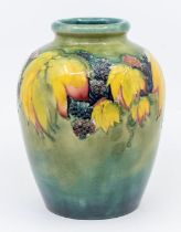 A large Moorcroft leaf and berry pattern glazed vase, signed, 16cm high. Condition: slight stains to