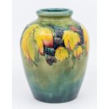 A large Moorcroft leaf and berry pattern glazed vase, signed, 16cm high. Condition: slight stains to