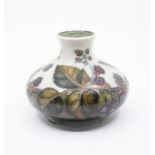 Moorcroft 'Bramble' pattern baluster vase. Height approx 10cm. No signs of damage. Crazing to the