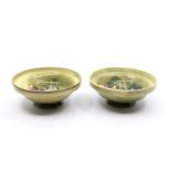 A pair of Moorcroft 'Spring Flower' small footed bowls designed by Walter Moorcroft on light green