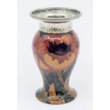 A small leaf and berry design vase with Tudric pewter band to the top. Approximately  11cm high.