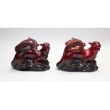 Two Royal Doulton Flambe griffins, 19cms high approx, 26cms long approx, both in good condition