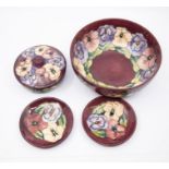 Moorcroft pottery - 'Pansy' - a large bowl, two pin dishes and a powder bowl