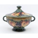 A Moorcroft berry-and-leaf patterned, lidded, two-handled bowl, approx.13cm high. Condition: good