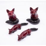 Four Royal Doulton Flambe foxes, largest height is 11cms approx, all good condition