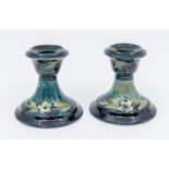 A pair of Moorcroft dark blue Berry pattern candlesticks, approx. 8cm high. Condition: good